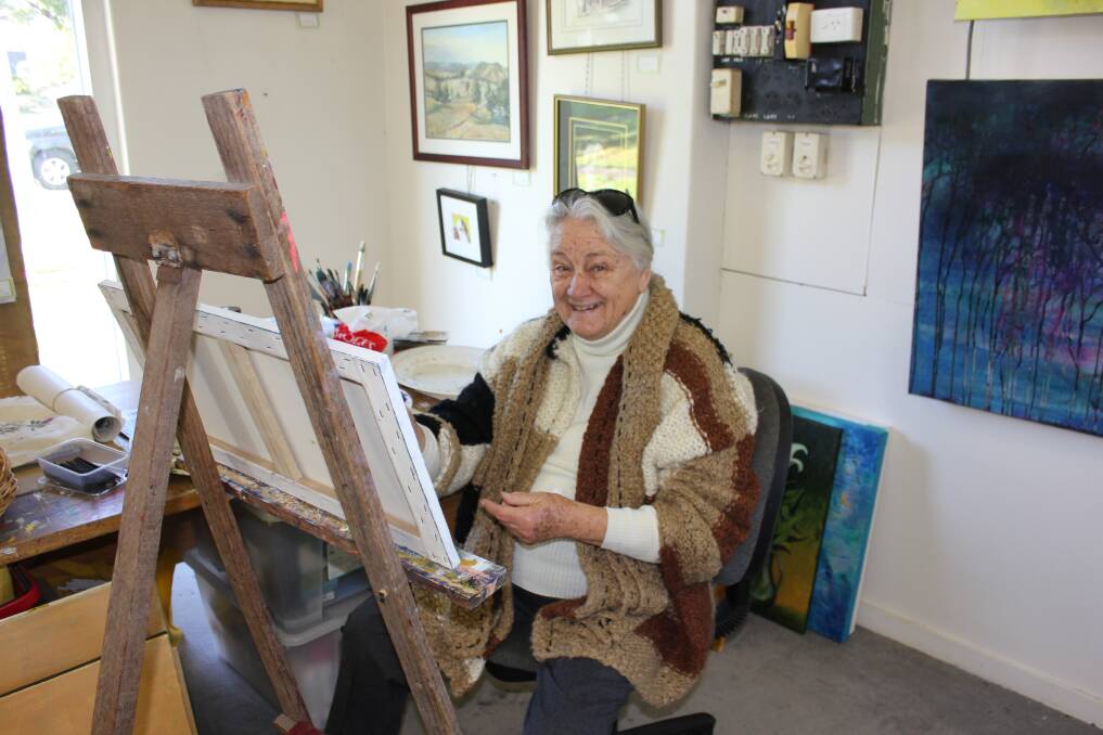 GETTING  READY: Art Society life member Wendy Grahame putting the finishing touches to her work for the exhibition.