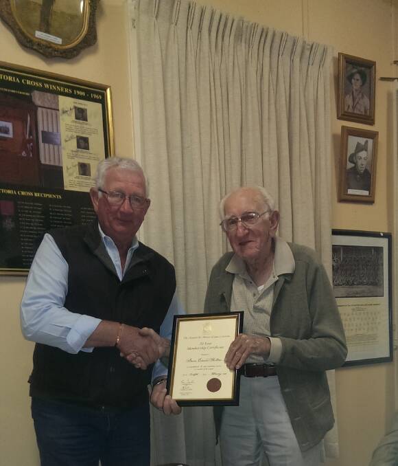 Neil Tickle, President of the Dungog RSL Sub-Branch.presents Bruce Shelton with  his RSL 50 year membership certificate.