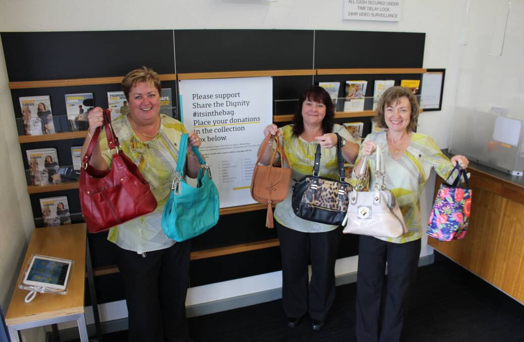TIME TO GIVE: Dungog Commonwealth Bank manager Karen Hancock with staff Donna Skinner and Karen Nairn are hoping to collect 30 handbags for women in need.