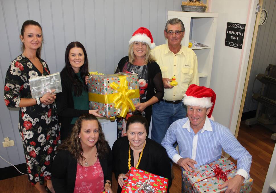 GIVING: Front: Karyn Marsh from Dungog Shire Community Centre with Ray White's Jessica Murray, Scott Hunter and (back) Tara Abot-Anderson, Chelsea Greentree, Dee Braithwaite and Rob Young are appealing for donations.