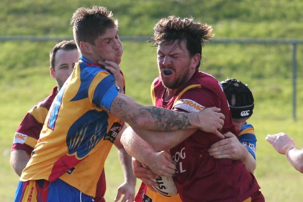 ON THE ATTACK: Matthew Hinton tries to fend off a Kearsley defender. Picture: Jeanie Briggs