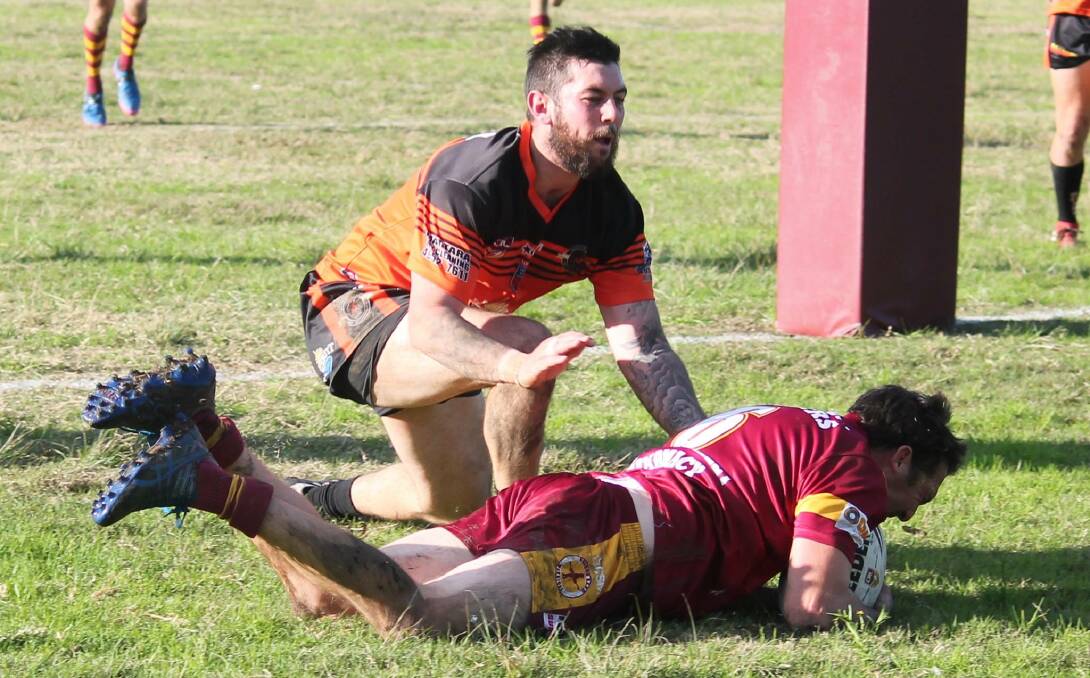 BACKING UP: Dungog Warriors five-eighth Jake Clifton crosses for a try after receiving a pass from halves partner Jeremy Fredericks against the Kotara Bears at Bennett Park on Sunday. Picture: Jeanie Briggs.