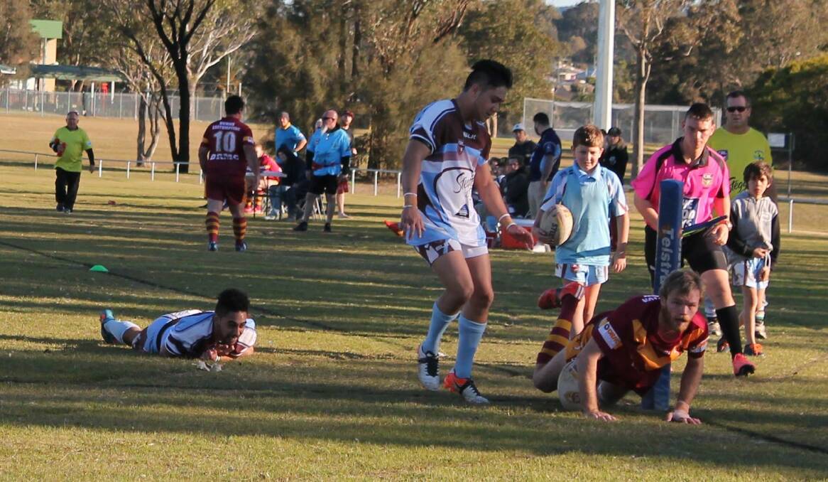 TREBLE: Dungog Warriors wing Aaron Cottam scores one of his three tries against Woodberry on Saturday. Picture: Jeanie Briggs.