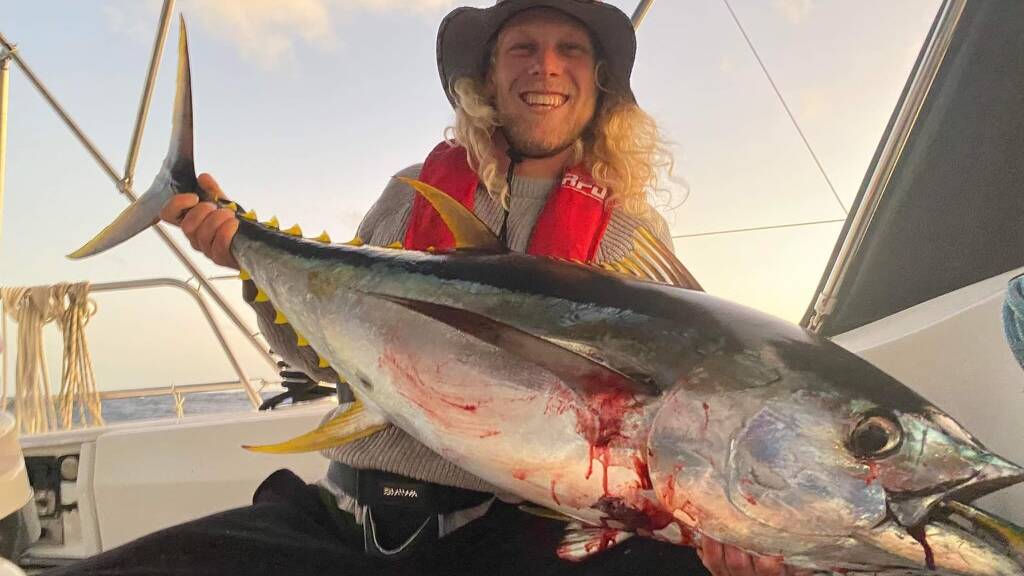 Dave with the yellowfin tuna with which they fed the dolphin. Picture supplied