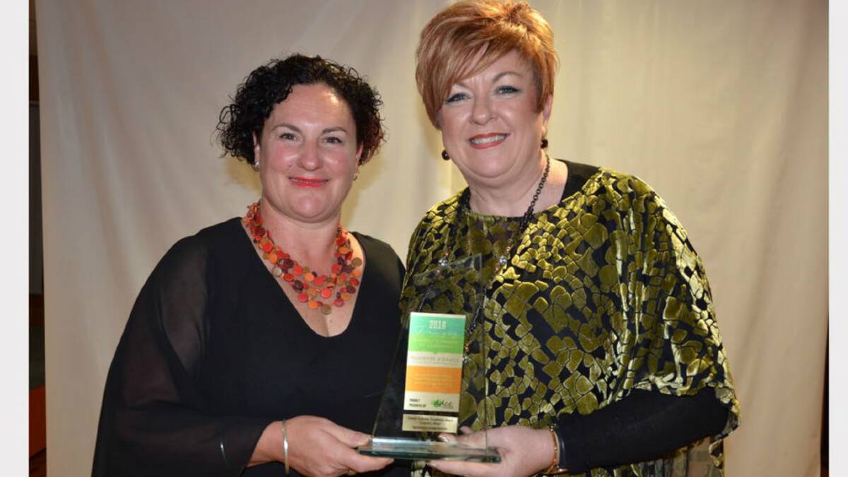 SUCCESS: Dungog Chronicle advertising consultant Bernadette Gallagher, left, presents A Country Affair owner Ann Dillon (right) the 2016 Overall Business Excellence Award last year.
