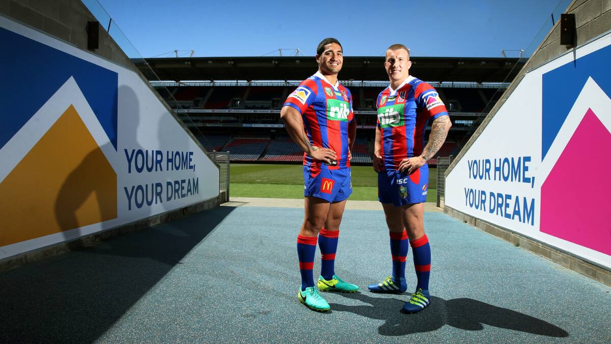 DONE DEAL: Knights skipper Trent Hodkinson and Sione Mata'utia model the new jerseys featuring McDonald Jones as sleeve sponsors. Picture: Marina Neil