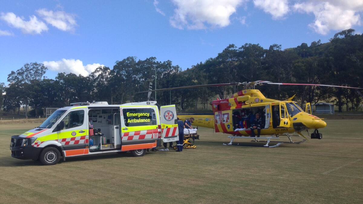 HORSE ACCIDENT: Dungog paramedics treating the injured man before he was airlifted to John Hunter Hospital.
