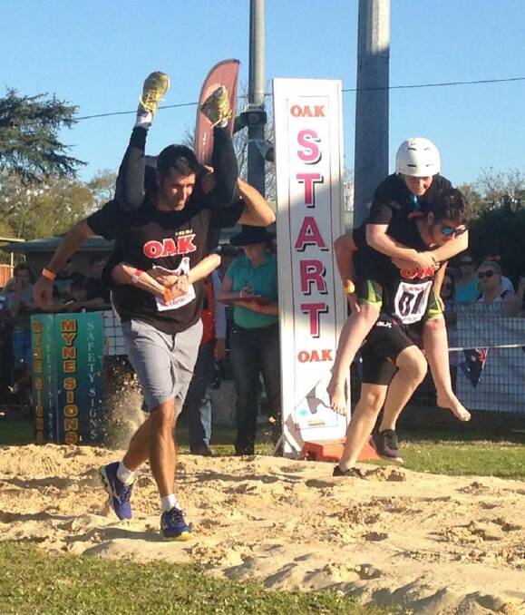 HOLD ON: The eleventh Australian Wife Carrying Titles were held at Singleton Show over the weekend. The victors, a Bellingen husband and wife, will compete in Finland next year. Picture: Supplied