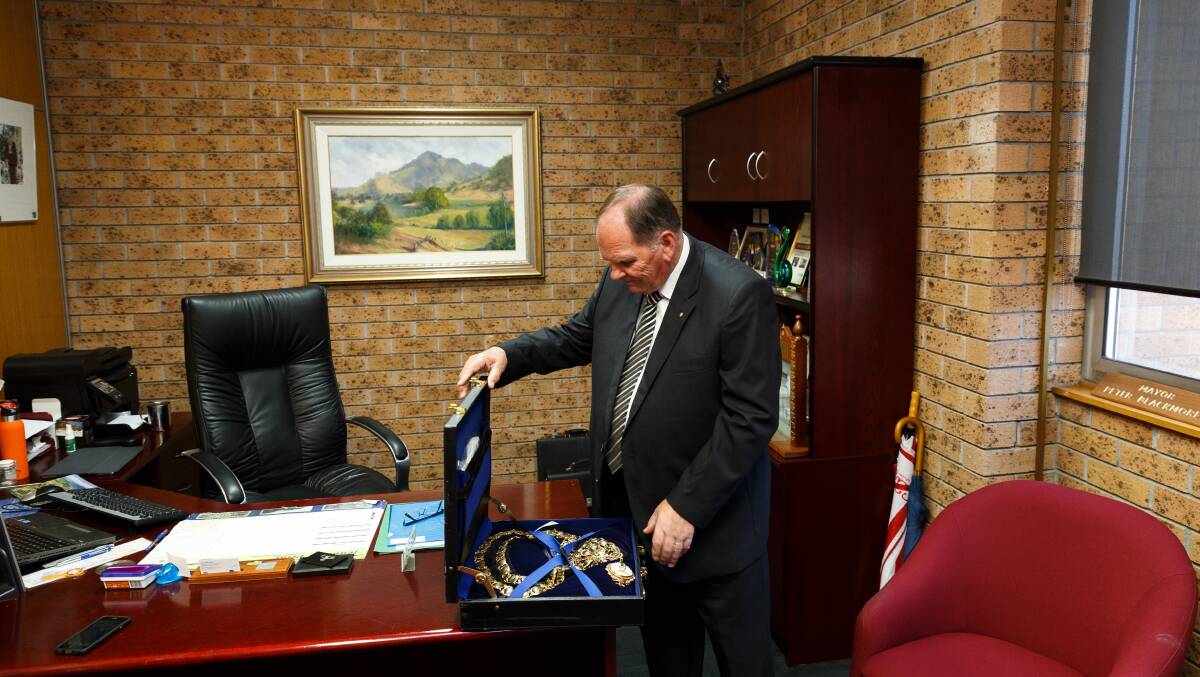Peter Blackmore packs away the mayoral chains. Picture: Max Mason-Hubers