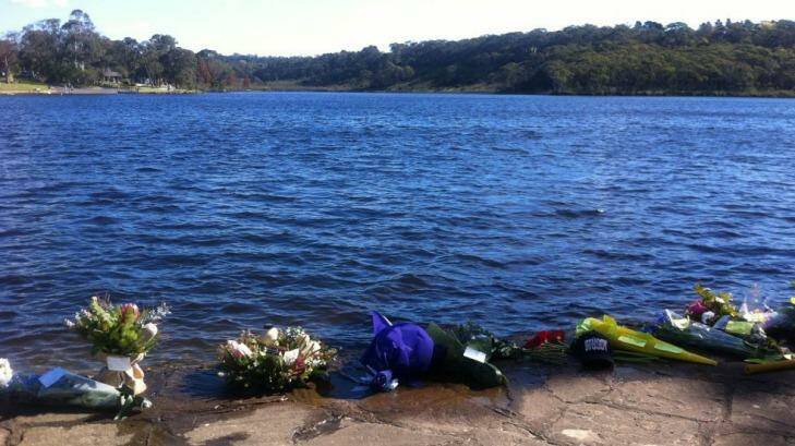 Bunches of flowers laid at Wentworth Falls Lake in the Blue Mountains by friends of Michael Ryall, who drowned while fishing in the lake  on Wednesday. Photo: Saffron Howden