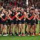 Essendon players can't hide their disappointment after the Anzac Day draw with Collingwood. (James Ross/AAP PHOTOS)