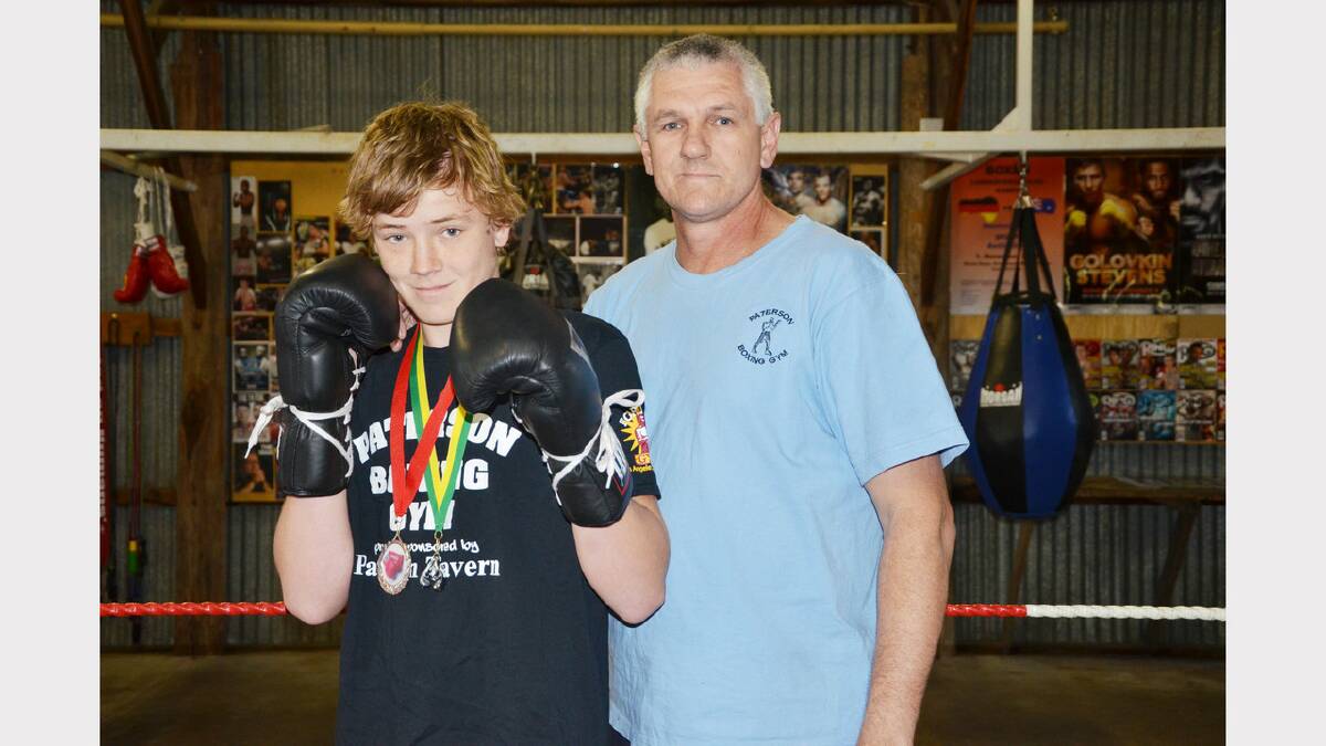 Junior boxer Will Grey with his two medals and coach Greg Tindall at the Paterson boxing gym