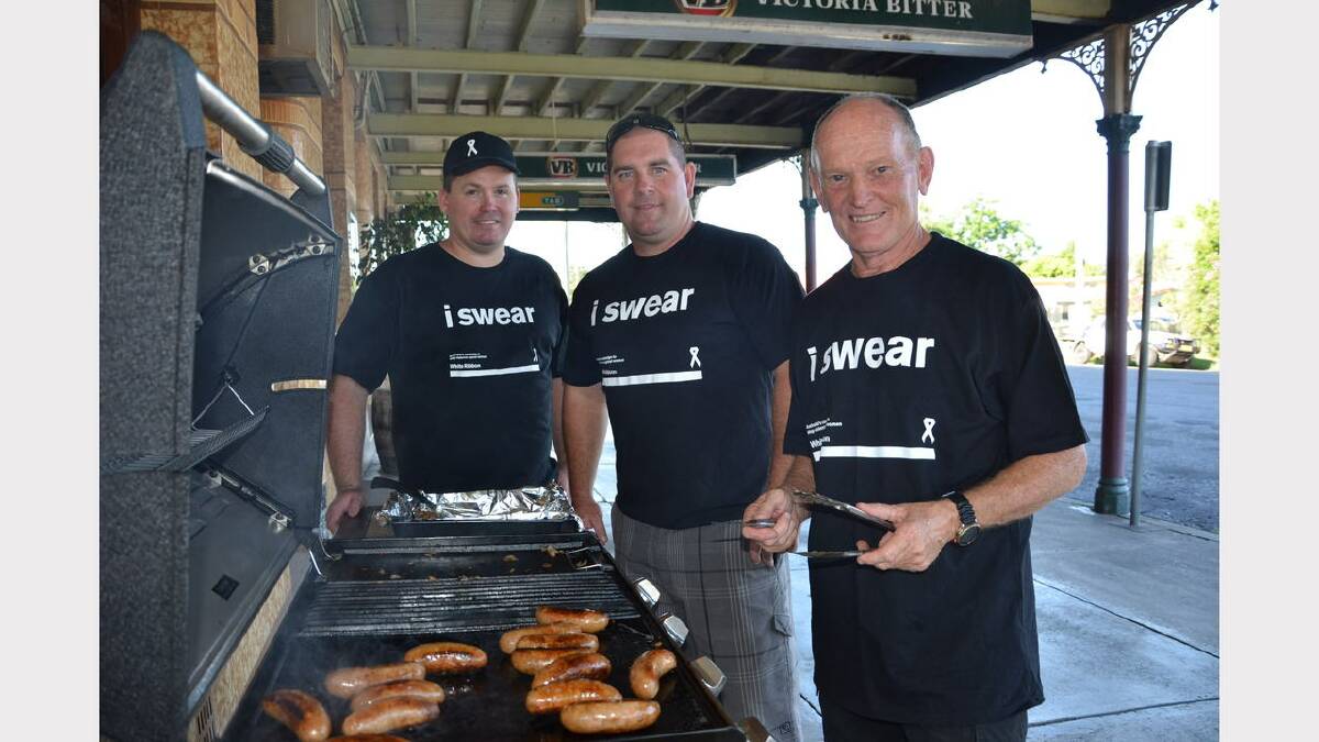 Beau Blanch, Chris Martin and David Langford at the White Ribbon Day sausage sizzle at the Bank Hotel on Wednesday