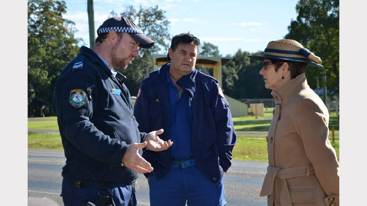 Senior Constable Brad Smith and paramedic Bill Rathbone from Stroud explaining to Mrs Hurley how the water rose so quickly at Stroud Showground on April 21.