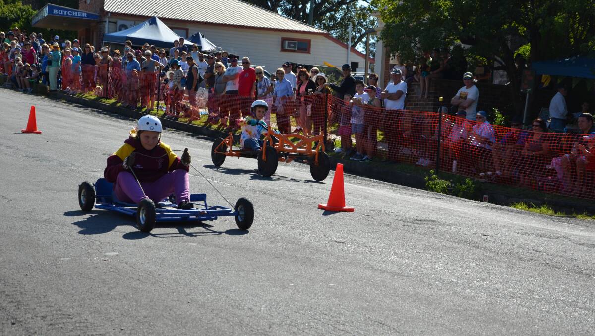 Yolanda Atchison beats her brother Angus to the finish line at the billy cart derby held in Gresford on Saturday