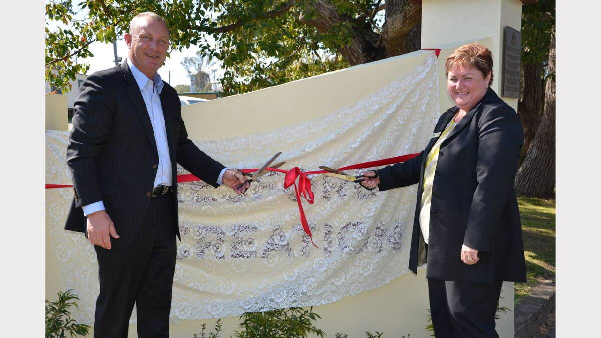 Michael Johnsen and Karen Hancock cutting the ribbon at the new gates