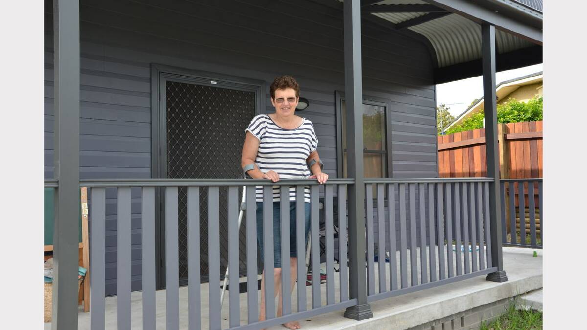 Kerri Gorton on the verandah of her newly rebuilt home
