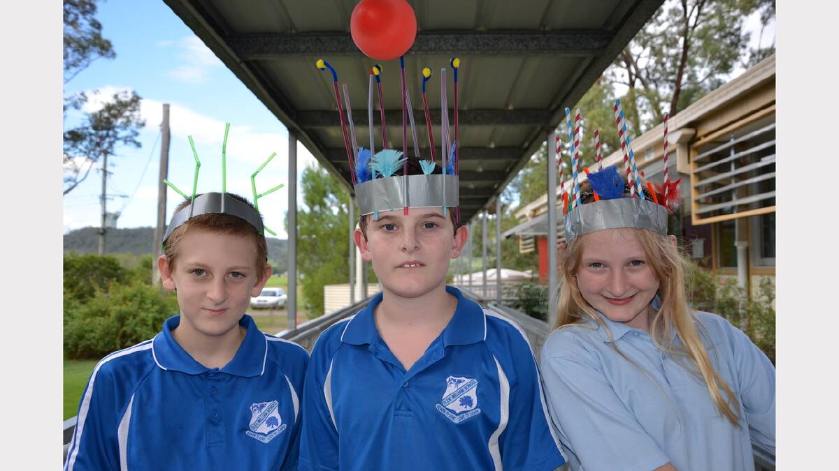 Alex Watkins, Brayden Dollimore and Grace Atkins having fun at the Easter hat parade at Glen William Public School on Friday.