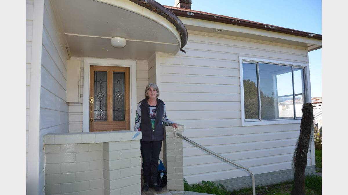 Rhonda Rolfe outside the house which flooded and she spent two hours on the roof.