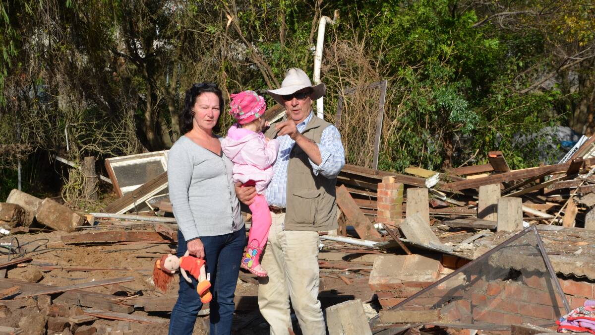 Vickie Burn, husband Peter and and her granddaughter in the remains of their Hooke Street home