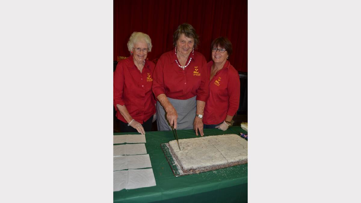 Dungog Lioness members Ruth Dircks, Joyce Byron and Jane Levick cutting up the Australia Day cake.  The organisation has been catering at Australia Day for over 25 years.