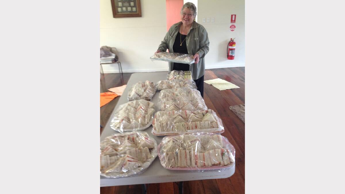 Elaine Eyb with a table full of sandwiches for lunch after the opening