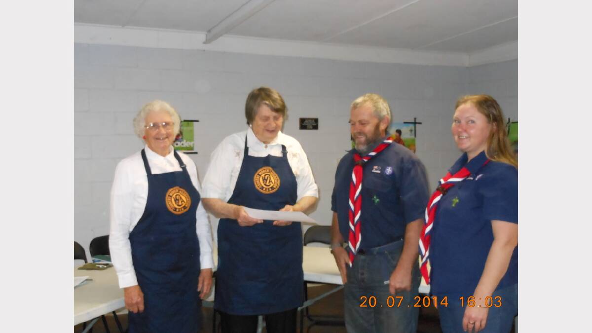 Dungog Evening CWA treasurer  Ruth Dircks and president Joyce Byron making a presentation to Terry Galbraith and Debbie Croker of 1st Dungog Scout Group.
