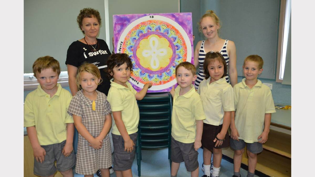 Lindy Salmon and daughter Erika with students Billy Hinton, Lilly Palmer, Oscar Berry, Alex Matheson, Georgina U’Brien and Jack Marks leaving their thumb prints on the harmony painting
