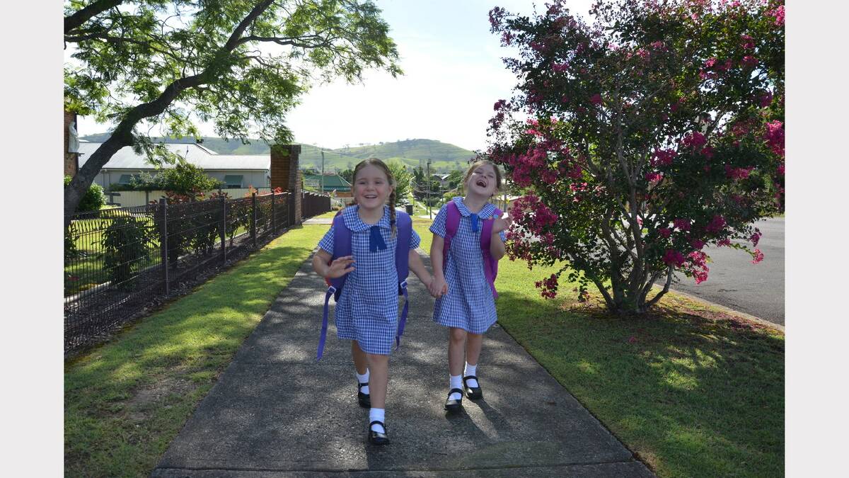 Mikayla Hancock and Lily Barrett testing out their new shoes, uniforms and backpacks at St Joseph's Primary School this week,