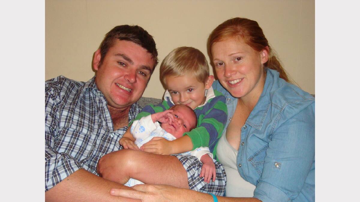 Ken and Rebecca Trappel with newborn Joseph and big brother Lachlan relaxing at home after his speedy delivery