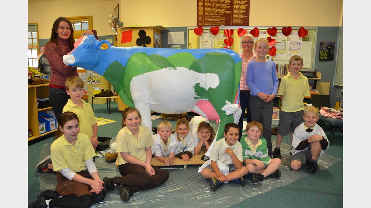 Giving their cow a make-over are Dungog Public School students, left, Callum Hooke, Mila Haluska, Becky Tickle; under cow, Andrew Jenkins, Kaylee Quinn, Ava Neilson; right, Lachlan Riley, Cooper Parish, Josh Watkins; standing Fiona Muller (left), teacher Robyn Norris, Charlee Lean and Lachlan Muddle. 