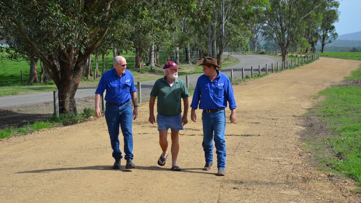 Main Creek dairy farmer Keith “Bluey” Watkins (centre) with Hunter Local Land Services district veterinarian Digby Rayward and senior biosecurity officer Luke Booth walking along one of the new roads to keep the cattle off Main Creek Road.