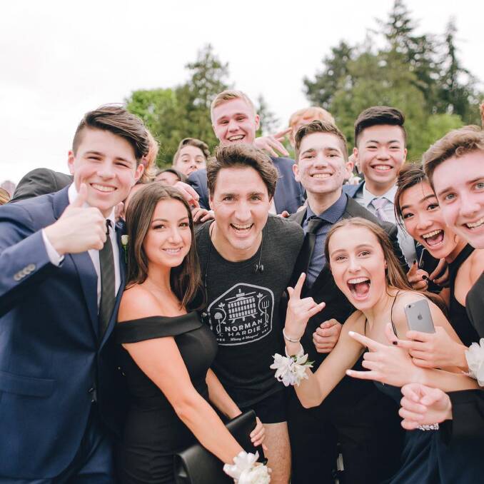 The Canadian Prime Minister poses for a prom photo with the group of students. 