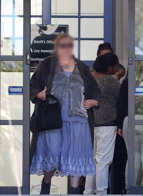 MYSTERY: The mother leaving court after an earlier appearance. 