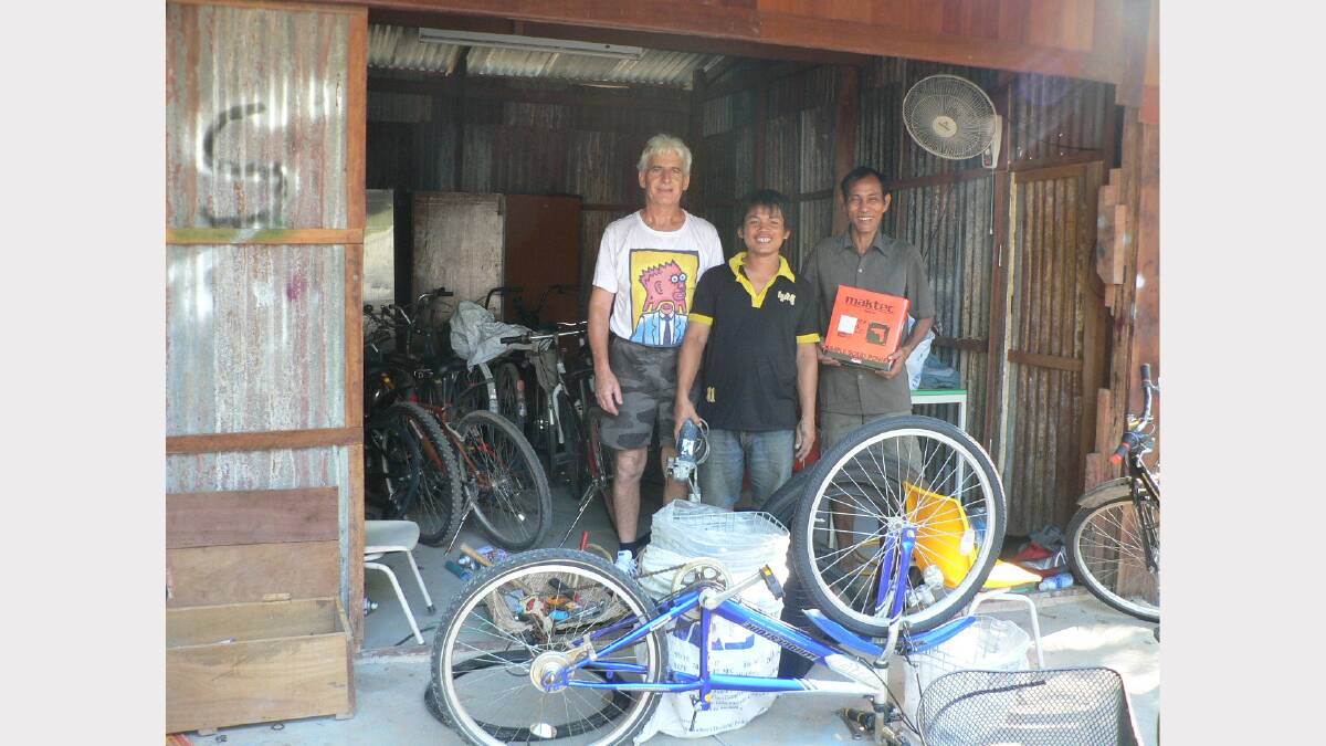 Richard Berry working with Cambodians in the bike store in Siem Reap