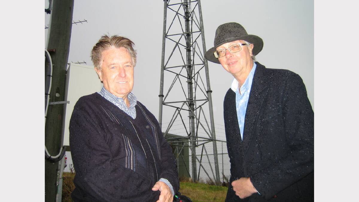 Radio Dungog station manager George Frame and president Simon Smith at Mount Richardson during the thunderstorm last Wednesday.