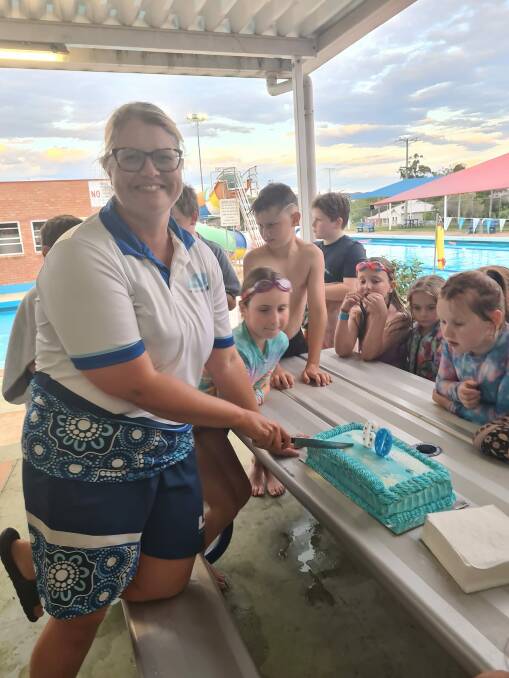 Casey Hynes cutting Dungog Swimming Pool's 60th birthday cake. Picture supplied.