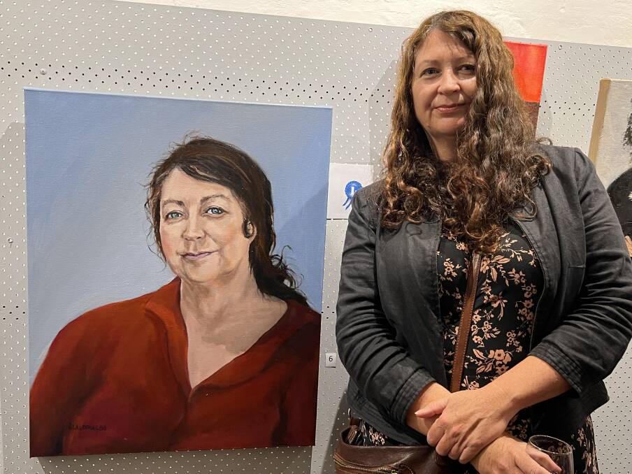 Suzannah Jones next to the winning portrait of herself by Sandra Lalopoulos. Picture by Angus Michie