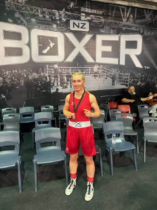 Shelby-Lee Wintle poses for a traditional boxing photo with her gold medal proudly hanging around her neck. Picture supplied