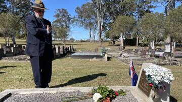 Nick Helyer paying his respects to another fallen Vietnam veteran. Picture by Angus Michie