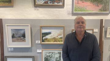 ART: Dungog Arts Society secretary and previous local artist winner Greg Mudie with one of his paintings. Picture: Angus Michie