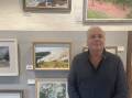 ART: Dungog Arts Society secretary and previous local artist winner Greg Mudie with one of his paintings. Picture: Angus Michie