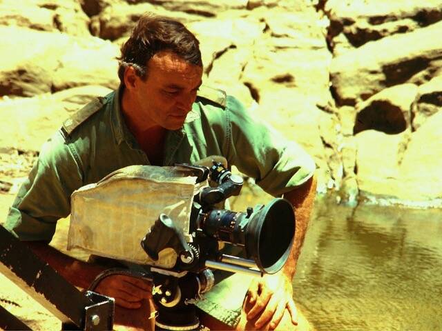 Mr Hiddins with camera during the filming of the ABC series "The Bush Tucker Man." Picture: supplied by Leslie Hiddins.