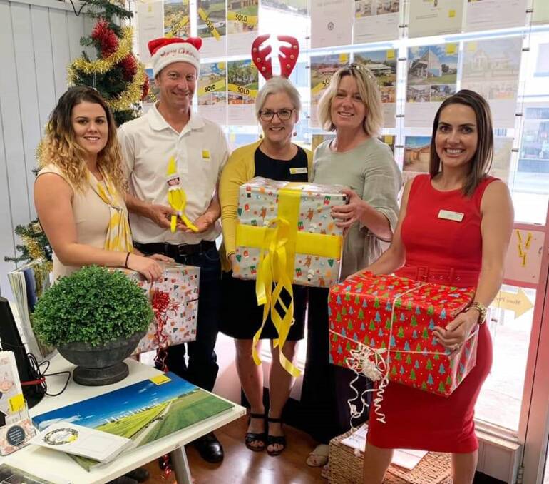 TEAM: This Christmas Ray White will continue its popular tradition of giving - Chelsea Greentree, Scott Hunter, Sally Kuppers, Dee Braithwaite and Jedda Casserly.