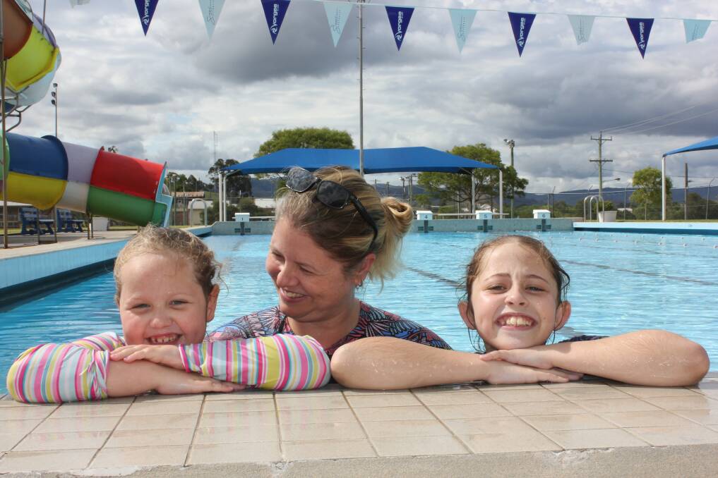 FUN: All smiles enjoying their first swim of the season at Dungog pool are Bonny Hynes with her mother Casey and sister Shayne. Picture: Michelle Mexon