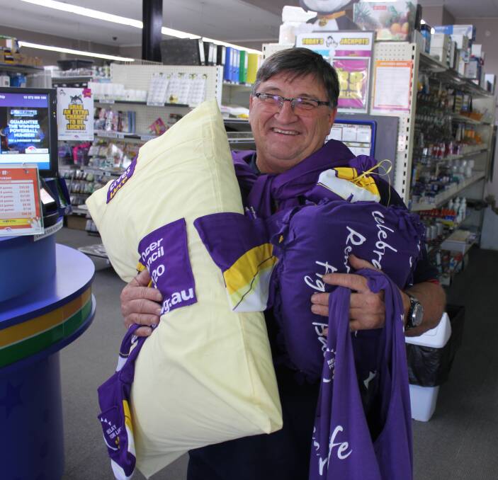 FUN: Long-time relay supporter Peter Maytom from Dungog Newsagency with some of the crafty ideas members have been coming up with to recycle their old relay shirts.