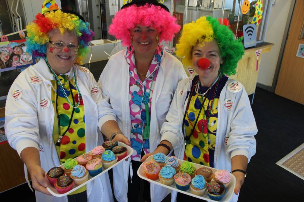FUN: Sam Rumbel, Karen Hancock and Karen Nairn got right into the spirit of the charity day at Dungog Commonwealth Bank to raise funds to provide more Clown Doctors.