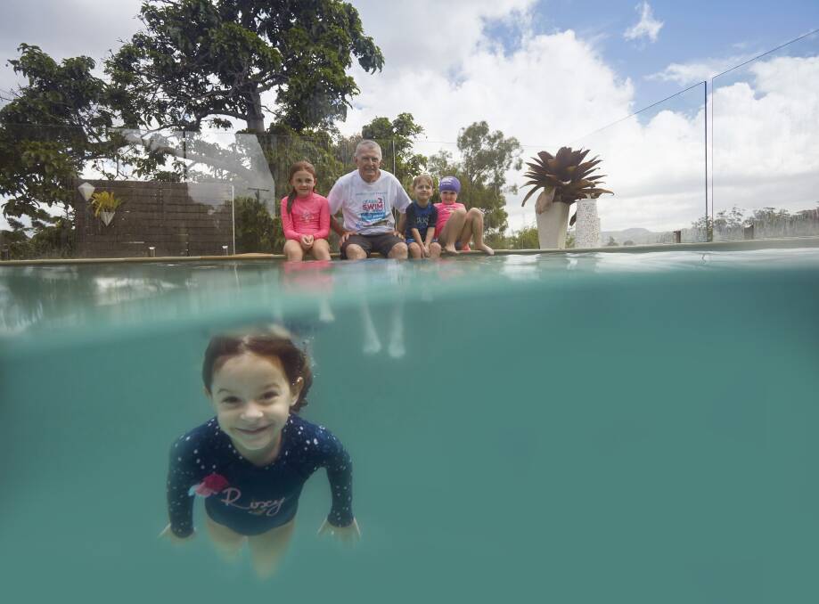 LESSONS: Laurie Lawrence watches a little one confident in and under the water.
