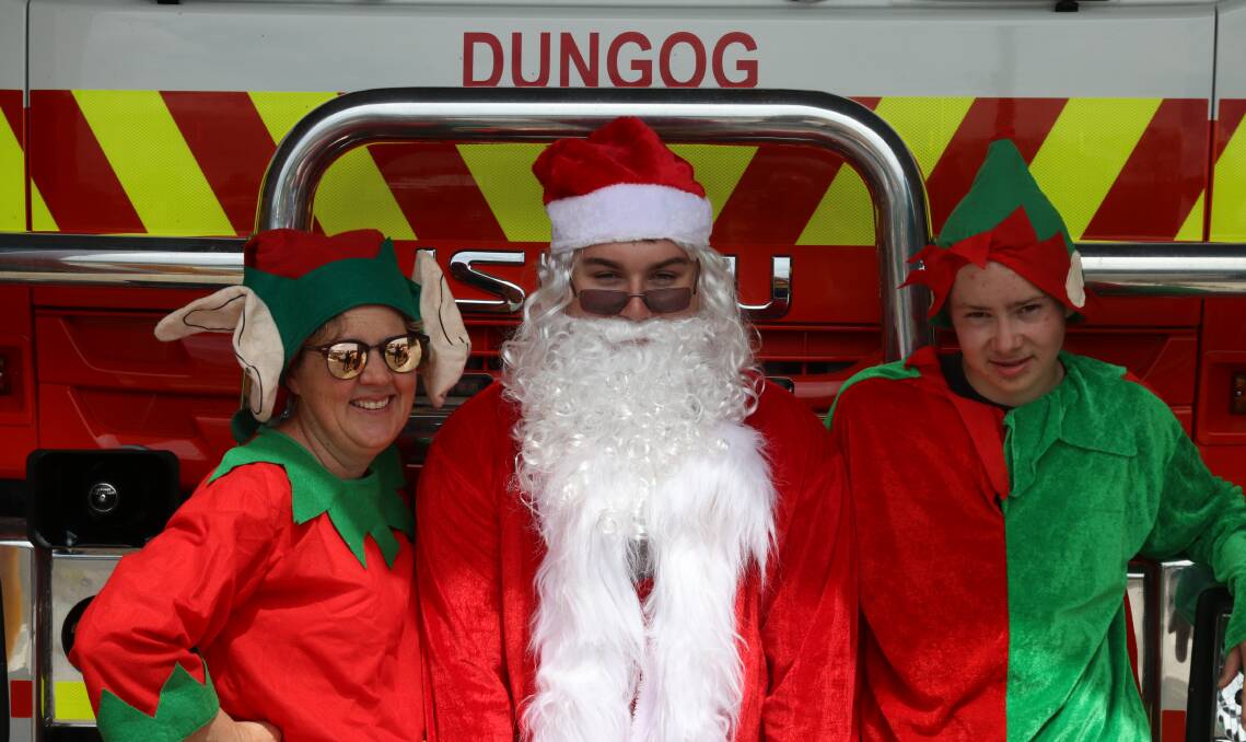 GETTING READY: Dungog RFS Brigade Captain Heidi Thornton with Santa (also known as Calvin Vogele) and Jesse Griffin ready for the annual lolly drop. 