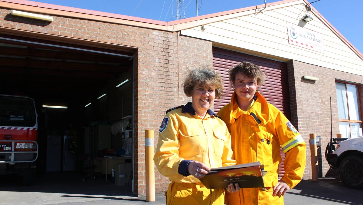 GET READY: Dungog Brigade Captain Heidi Thornton with RFS member Toby Griffith with a copy of the Bushfire Survival Plan which will be available on the day.
